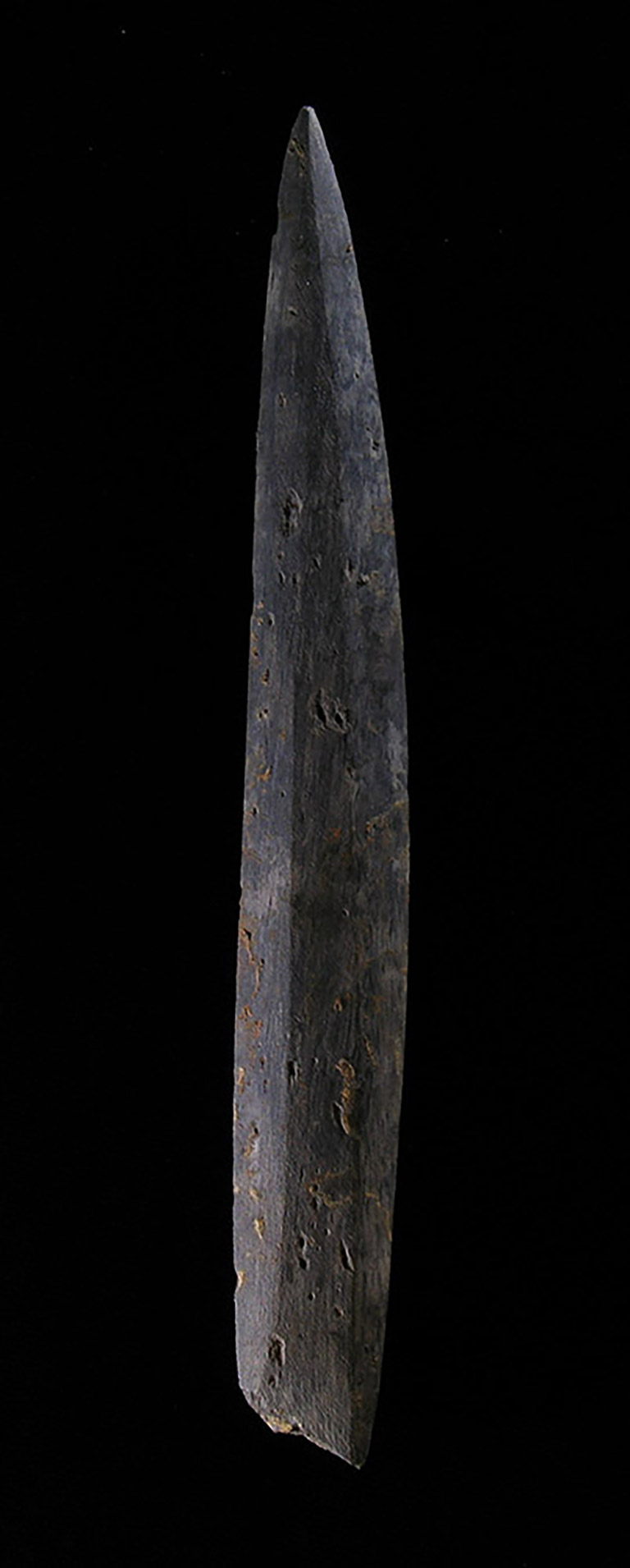 Long, narrow piece of dark stone tapers into a point at the top.